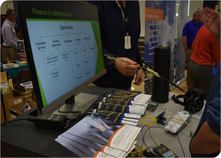 2017 STEM presentation with marketing material by a computer