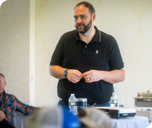 Image of our CEO, Bryan Gabriel, standing in front of a crowd, giving a speech.