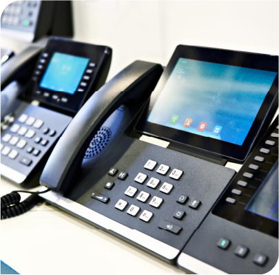 Picture of Manged Voice phones in a line on a desk