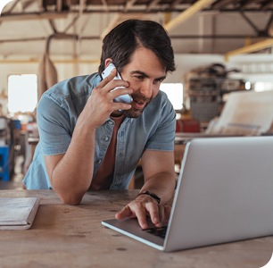 businessman talking on cellphone when using laptop